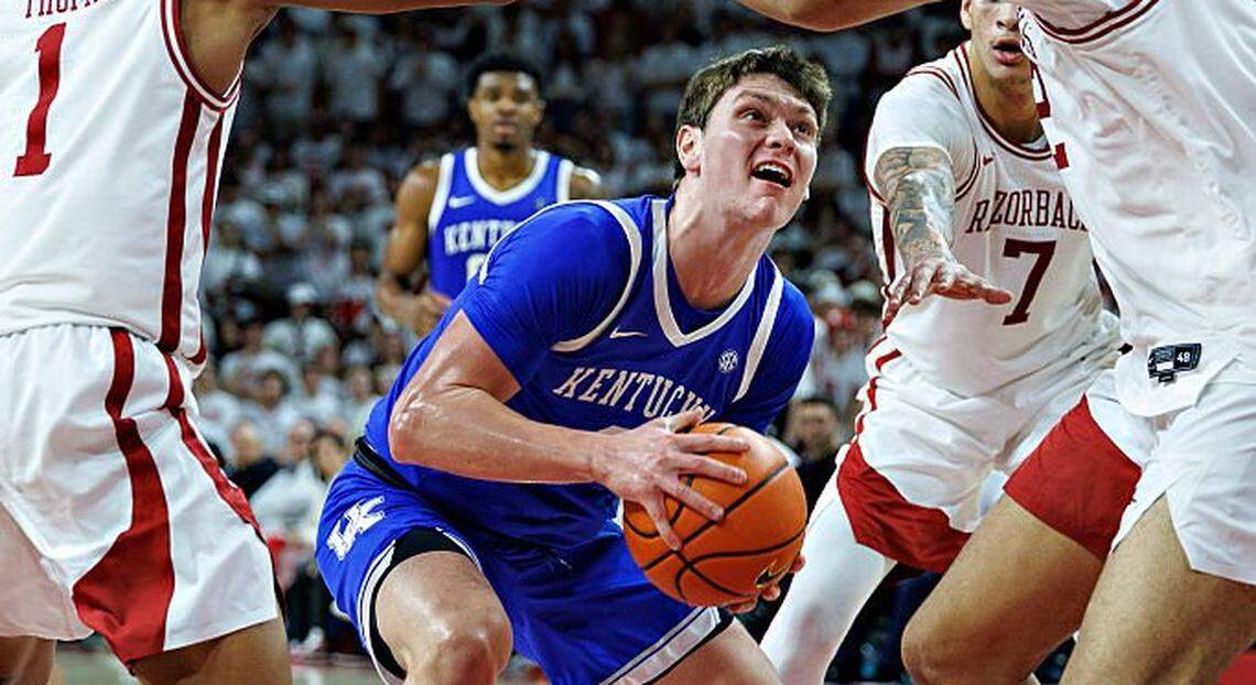 Kentucky forward Trent Noah (9) of the Kentucky Wildcats attempts to go up for a shot in the second half against Arkansas’ Meleek Thomas (1) and Malique Ewin on Saturday night at Bud Walton Arena in Fayetteville, Arkansas. The Wildcats defeated the Razorbacks 85-77.  