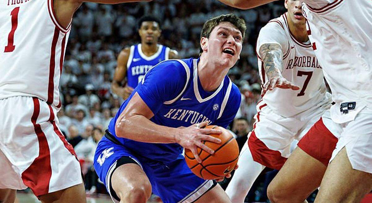 Kentucky forward Trent Noah (9) of the Kentucky Wildcats attempts to go up for a shot in the second half against Arkansas’ Meleek Thomas (1) and Malique Ewin on Saturday night at Bud Walton Arena in Fayetteville, Arkansas. The Wildcats defeated the Razorbacks 85-77.  