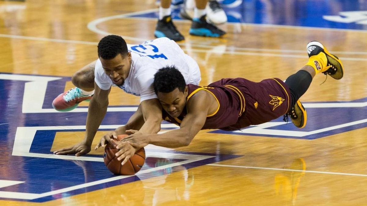 Kentucky guard Isaiah Briscoe, left, dove for a loose ball with Arizona State guard Tra Holder in the first half on Saturday, Dec. 12, 2015, in Lexington.