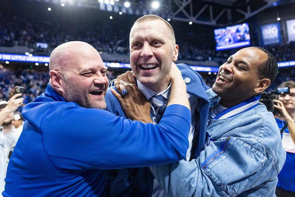 Former Kentucky teammates Cameron Mills, left, and Derek Anderson, right, congratulate Mark Pope after UK defeated Tennessee in Rupp Arena last Saturday night.