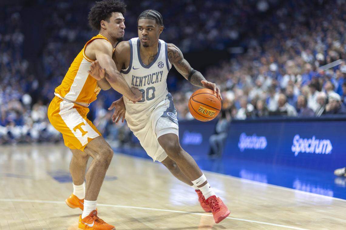 Kentucky Wildcats guard Otega Oweh (00) drives the ball as Tennessee Volunteers guard Bishop Boswell (3) defends during a game at Rupp Arena in Lexington, Ky., on Saturday, Feb. 7, 2026. 