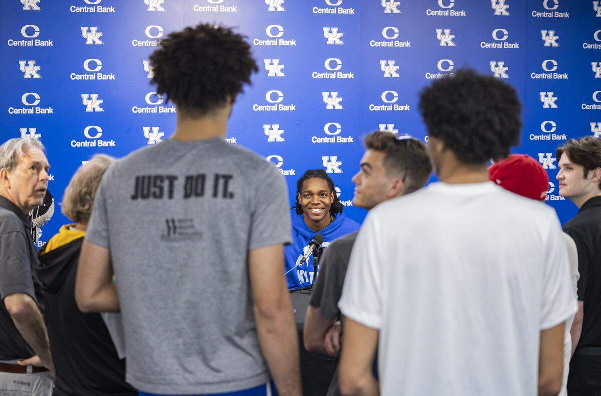 Jasper Johnson smiles as Kentucky basketball teammates Malachi Moreno and Braydon Hawthorne ask him questions during an interview session with reporters.