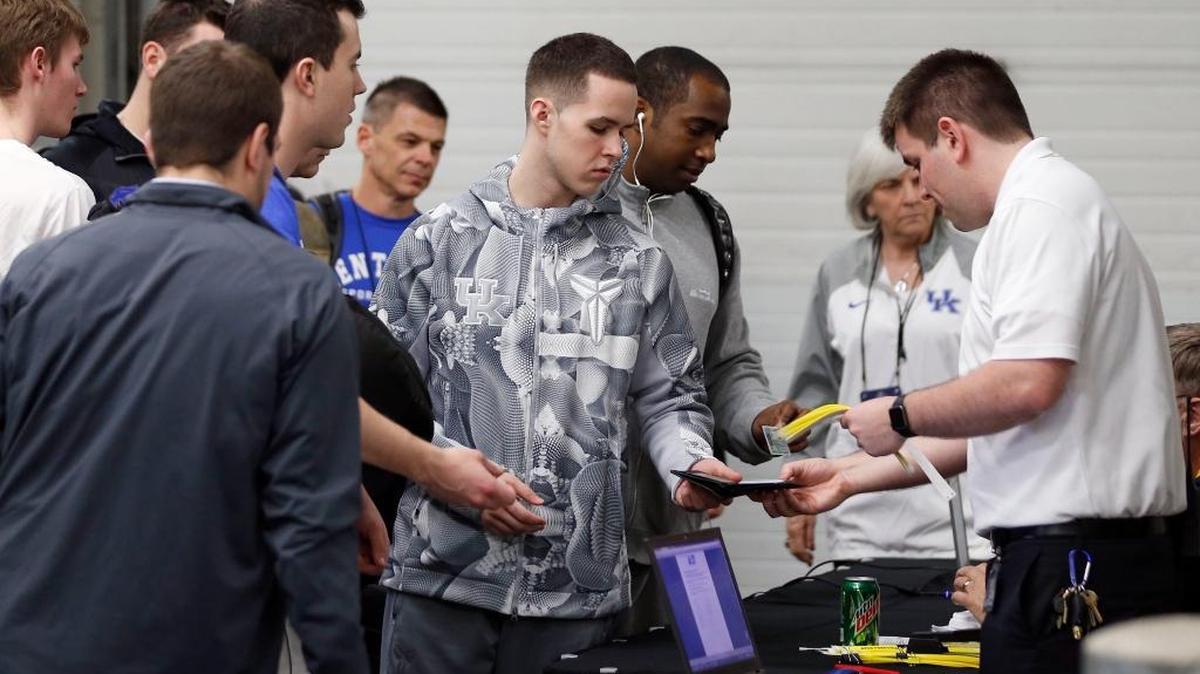 Brad Calipari, son of Coach John Calipari, showed his ID as UK checked in for practice last month before their NCAA first-round game versus Stony Brook in Des Moines, Iowa.