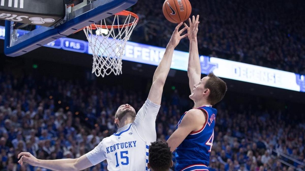 Kentucky Wildcats forward Isaac Humphries (15) disrupted Kansas Jayhawks guard Devonte’ Graham (4) during the first half as UK hosted Kansas at Rupp Arena on Saturday Jan. 28, 2017 in Lexington, Ky.