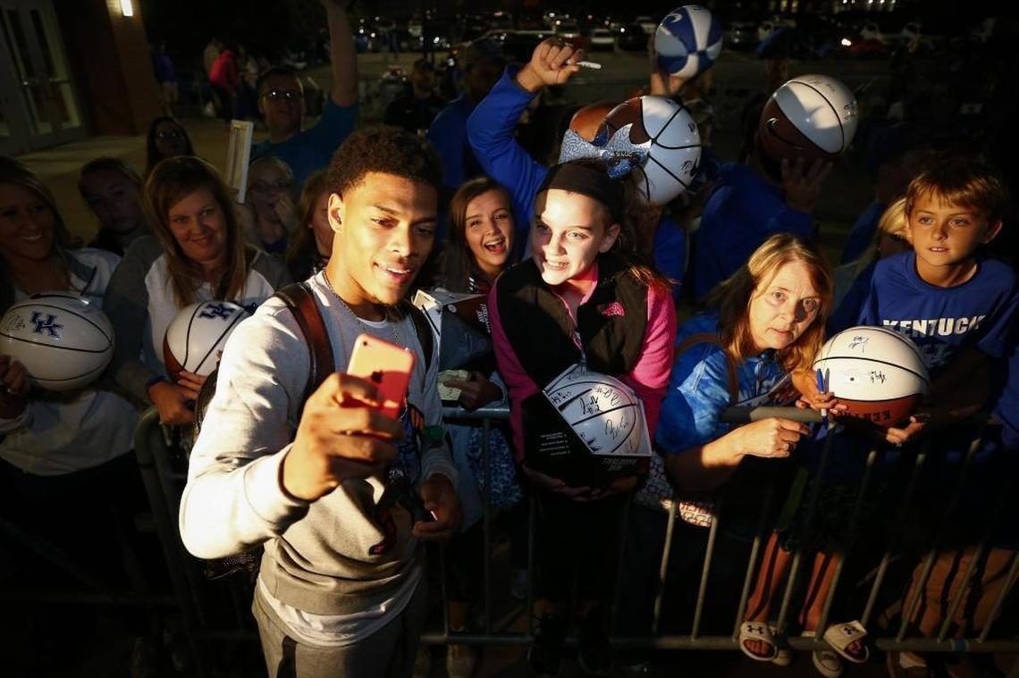 Athena Roten, 11, of Hodgenville, right, posed for a picture with Kentucky basketball player Quade Green at Memorial Coliseum in Lexington on Sept. 28, 2017. UK players served pizza and signed autographs for fans who camped out during Big Blue Madness.