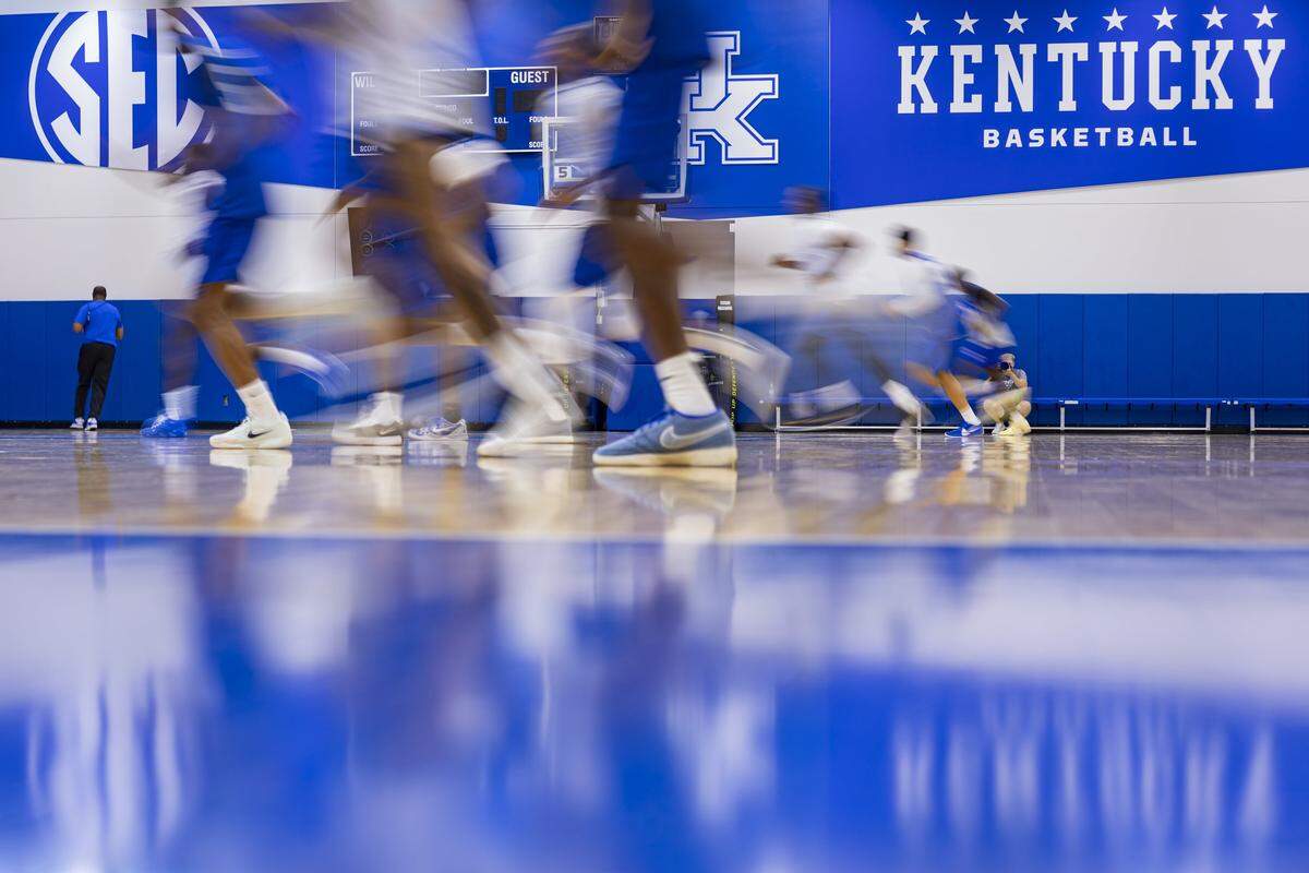 Former Kentucky basketball players run during the La Familia team’s media day event at the Joe Craft Center in July.