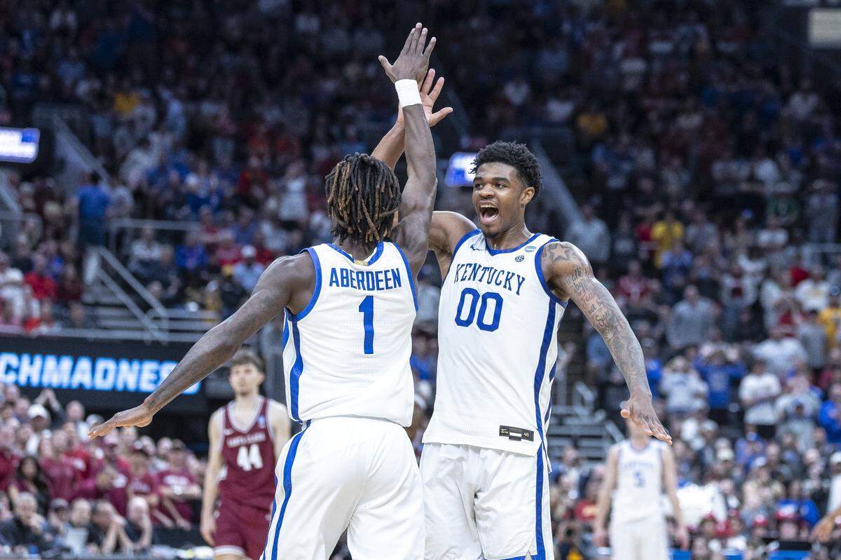 Kentucky Wildcats guard Otega Oweh (00) and Kentucky Wildcats guard Denzel Aberdeen (1) celebrate in a game against the Santa Clara Broncos during the first round of the NCAA men’s basketball tournament at Enterprise Center in St. Louis, Mo., on Friday, March 20, 2026. 