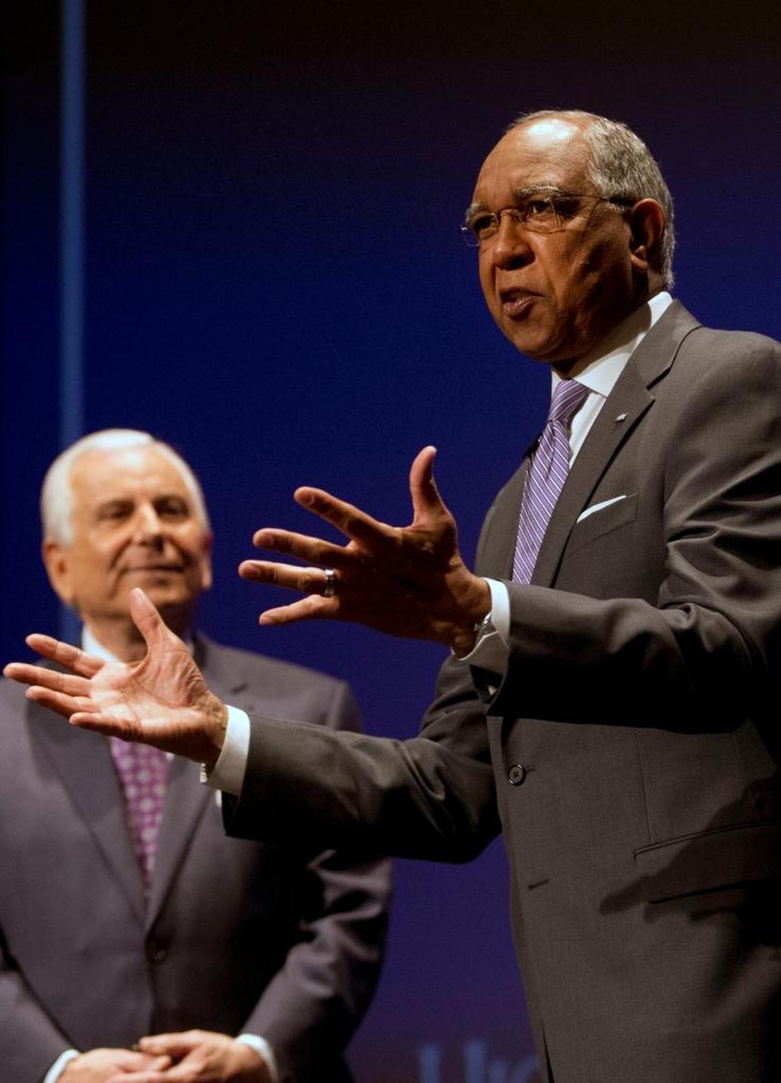 Tubby Smith gestures during an introductory press conference as High Point University president Nido Qubein looks on in High Point, N.C., Tuesday, March 27, 2018. Smith is the new NCAA college basketball head coach at the school.