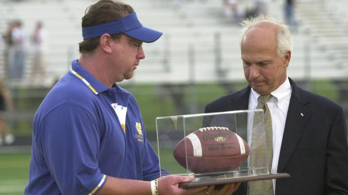 Robert “Jake” Bell, right, received a game ball from Henry Clay Athletics Director Charles Atinay when the stadium was named in Bell’s honor in 2006.