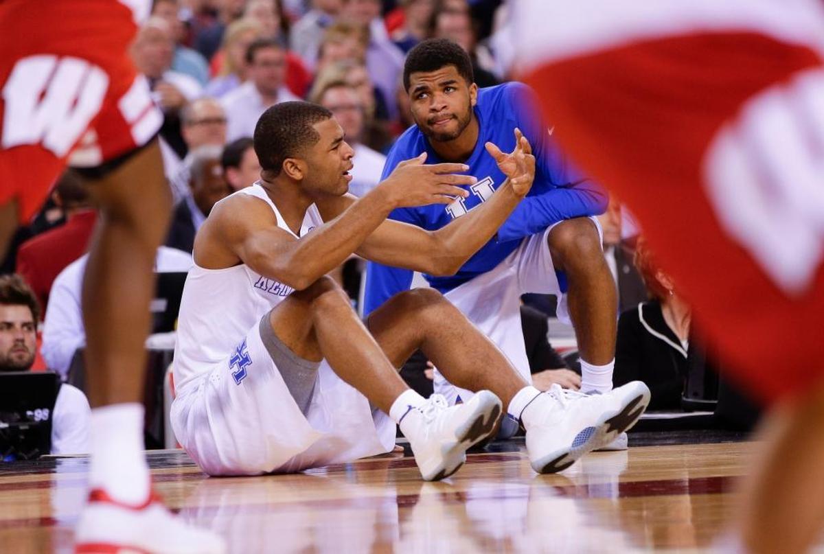 Wisconsin ended Kentucky’s dreams of a 40-0, NCAA title with a 71-64 victory over the Wildcats and guard Aaron Harrison, seated, in the 2015 Final Four.