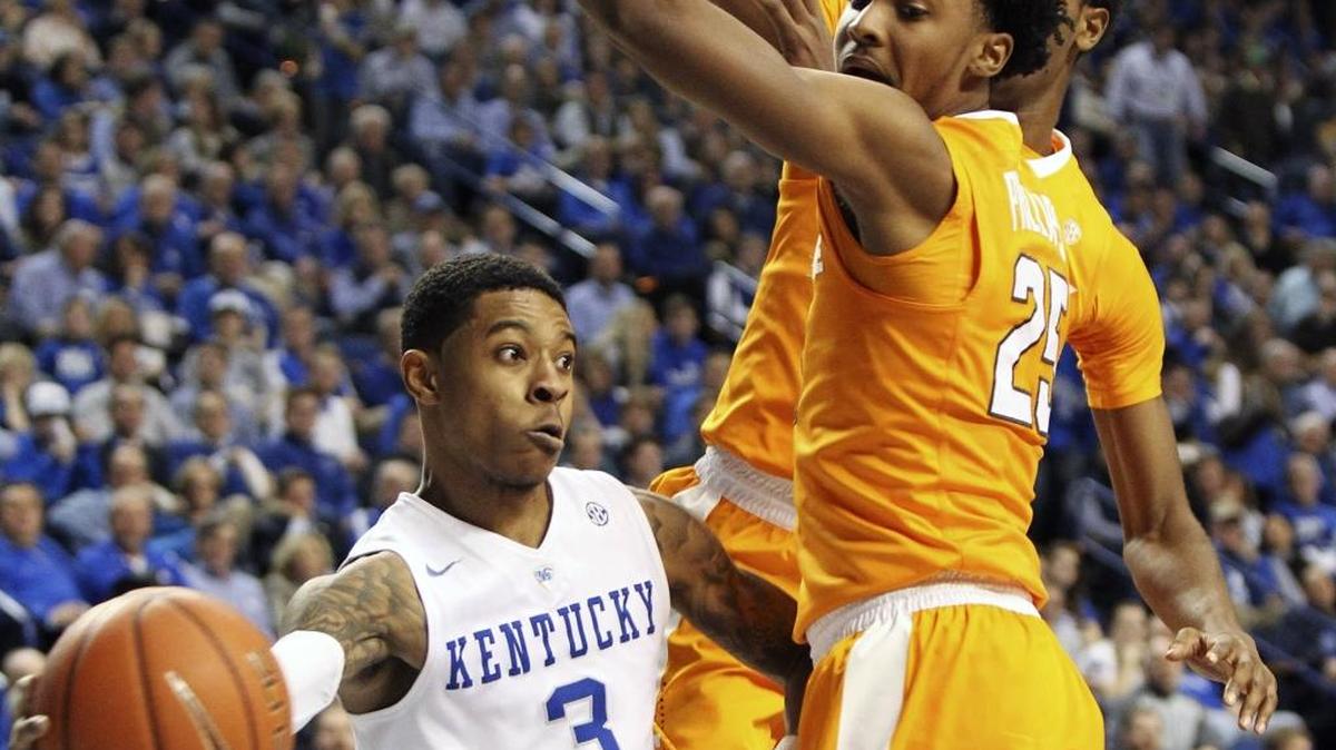 Kentucky's Tyler Ulis (3) passes around Tennessee's Shembari Phillips (25) and Kyle Alexander during the second half of an NCAA college basketball game Thursday, Feb. 18, 2016, in Lexington, Ky. Kentucky won 80-70.