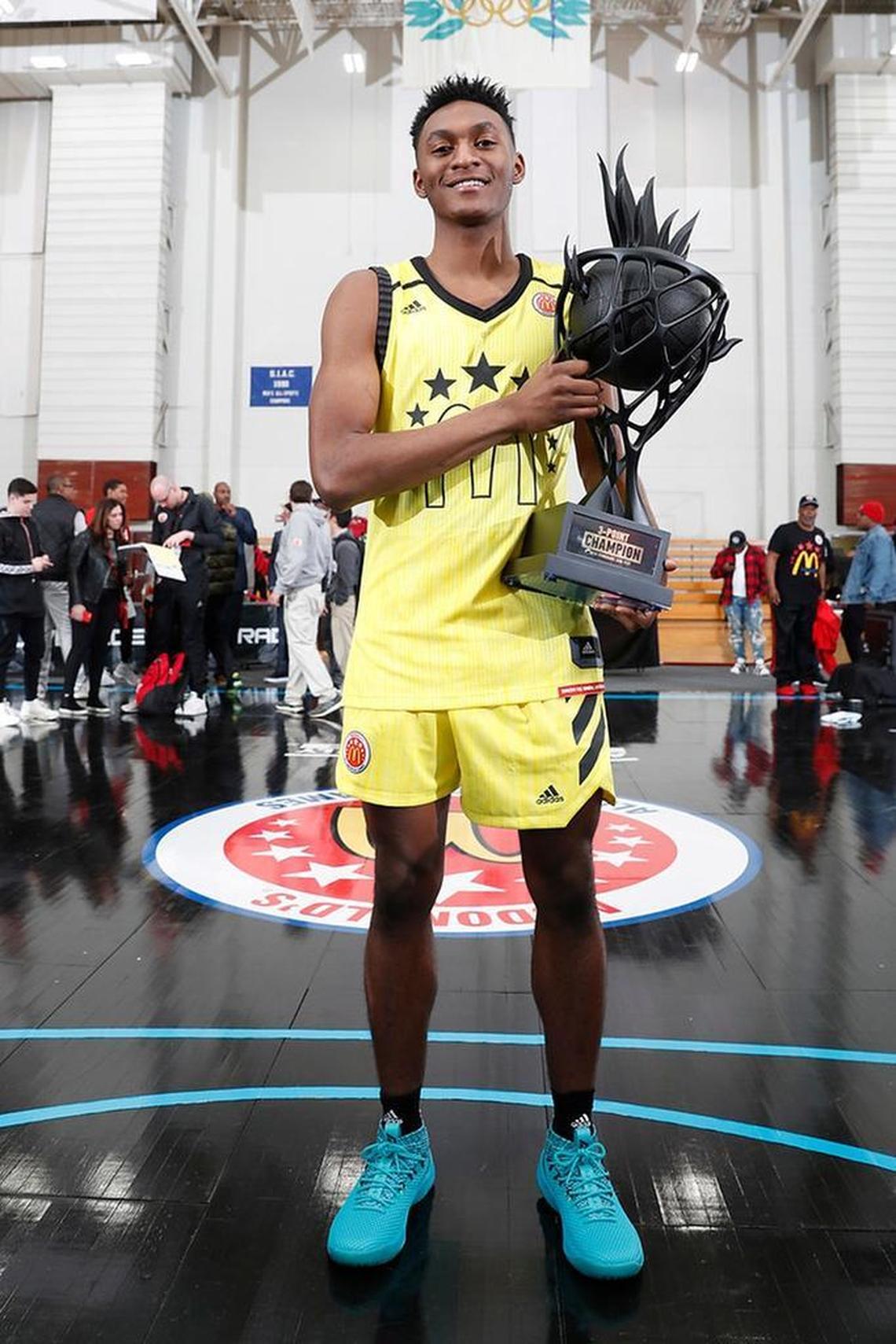 Immanuel Quickley poses with his McDonald’s three-point contest trophy.