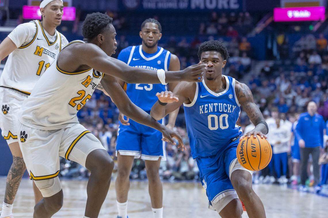 Kentucky Wildcats guard Otega Oweh (00) drives the ball as Missouri Tigers forward Mark Mitchell (25) defends during the SEC Tournament at Bridgestone Arena in Nashville, Tenn., on Thursday, March 12, 2026. 