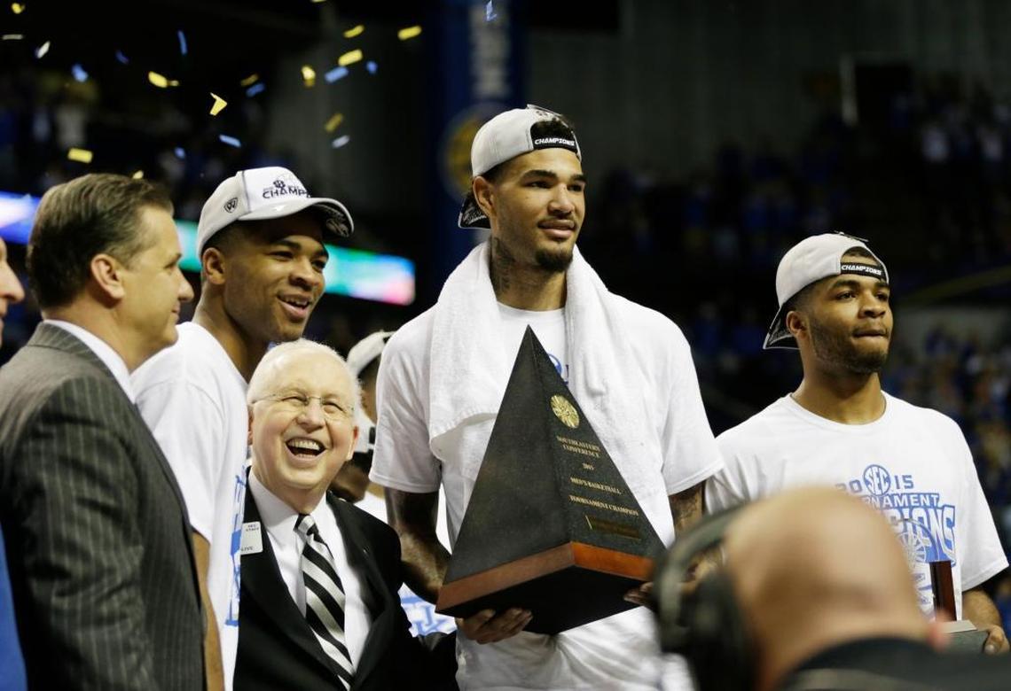 Then-SEC commissioner Mike Slive, flanked by Aaron Harrison, left, MVP Willie Cauley-Stein holding the trophy and Andrew Harrison, right, with Kentucky head coach John Calipari, at left, posed for photographs after the SEC Tournament championship game in 2015. Kentucky beat Arkansas 78-63 to win the title.