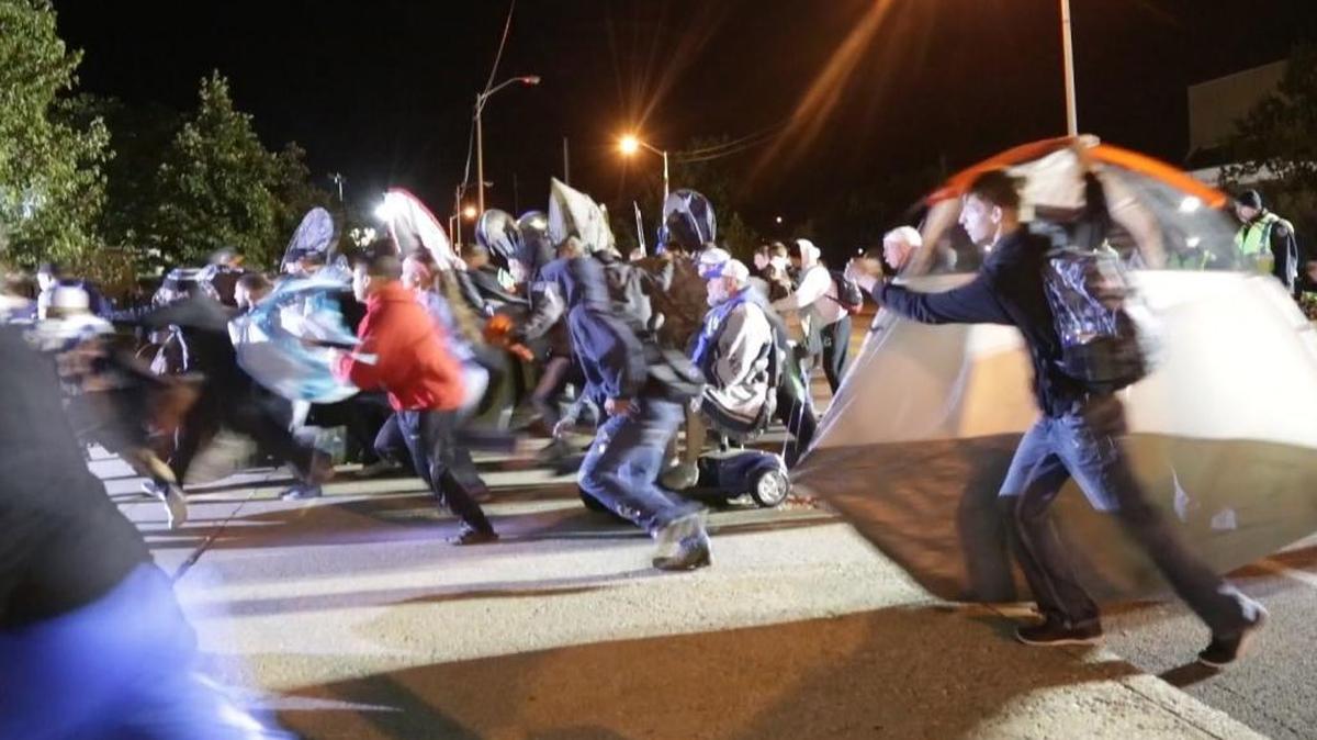 Fans ran across Avenue of Champions from Memorial Coliseum during a mad dash for camping spots in Lexington, Ky, on Sept. 28, 2016. Free tickets are distributed on Friday. Tickets will also be available online through Ticketmaster.