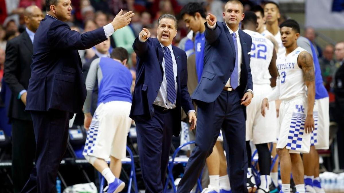 Assistant coaches Tony Barbee, left, and Joel Justus, right, flanked Kentucky head coach John Calipari during the Wildcats’ NCAA Tournament game against Indiana in Des Moines, Iowa, last March.