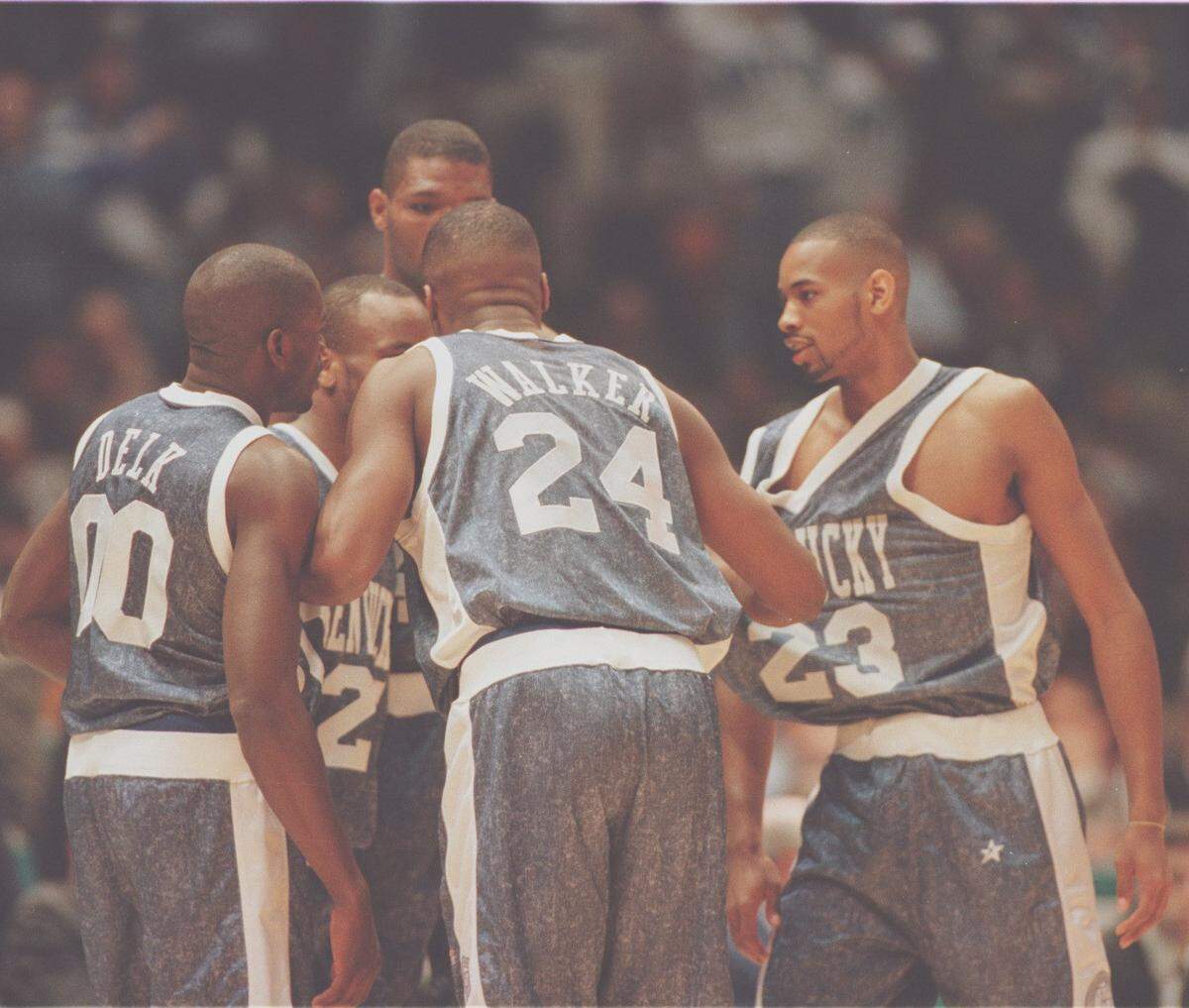 The Kentucky Wildcats huddle up in their denim uniforms during a Final Four victory over UMass in the 1996 NCAA Tournament.