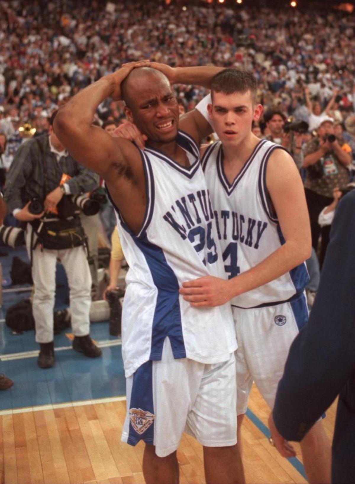 UK’s Anthony Epps, left, was consoled by teammate Steve Masiello after Kentucky’s overtime loss to Arizona in the 1997 NCAA finals.