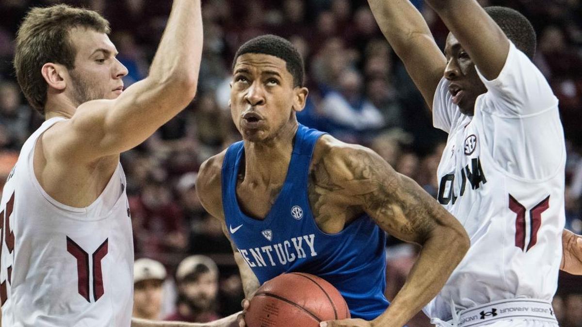 Kentucky guard Charles Matthews, center, drives to the hoop between South Carolina forward Mindaugas Kacinas, left, and Marcus Stroman, right, during the second half of an NCAA college basketball game Saturday, Feb. 13, 2016, in Columbia, S.C. Kentucky defeated South Carolina 89-62.