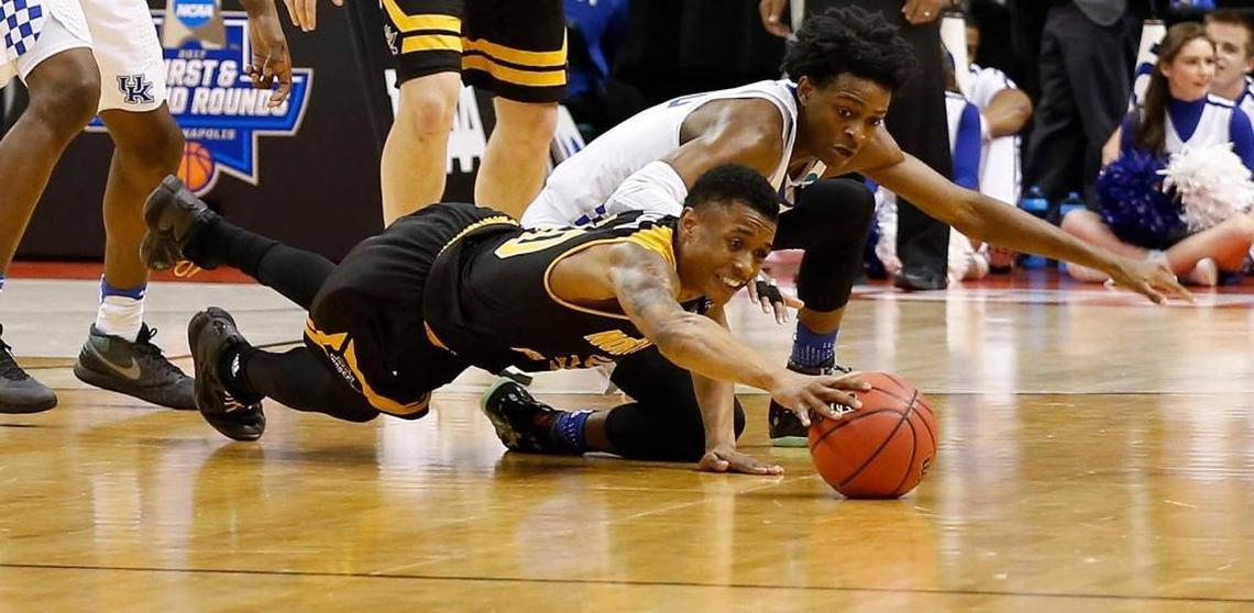 Northern Kentucky guard Lavone Holland II battled for a loose ball with Kentucky’s De’Aaron Fox in NKU’s 79-70 loss to UK in the NCAA Tournament. Holland, a Ballard product, had a game-high 22 points.