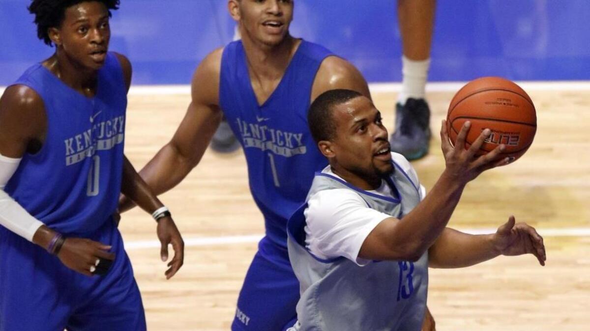 Kentucky's Isaiah Briscoe, right, shoots while teammates De’Aaron Fox (0) and Sacha Killeya-Jones (1) defend during the team’s Big Blue Madness last Friday.