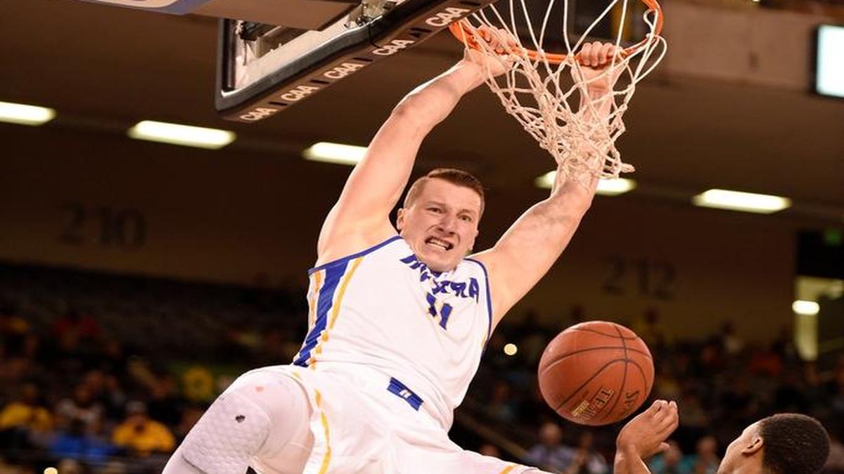 Hofstra forward Rokas Gustys (11) dunked over UNC Wilmington guard Craig Ponder during the Colonial Athletic Association Championship in March. Gustys is the nation’s leading rebounder with an average of 13.5.