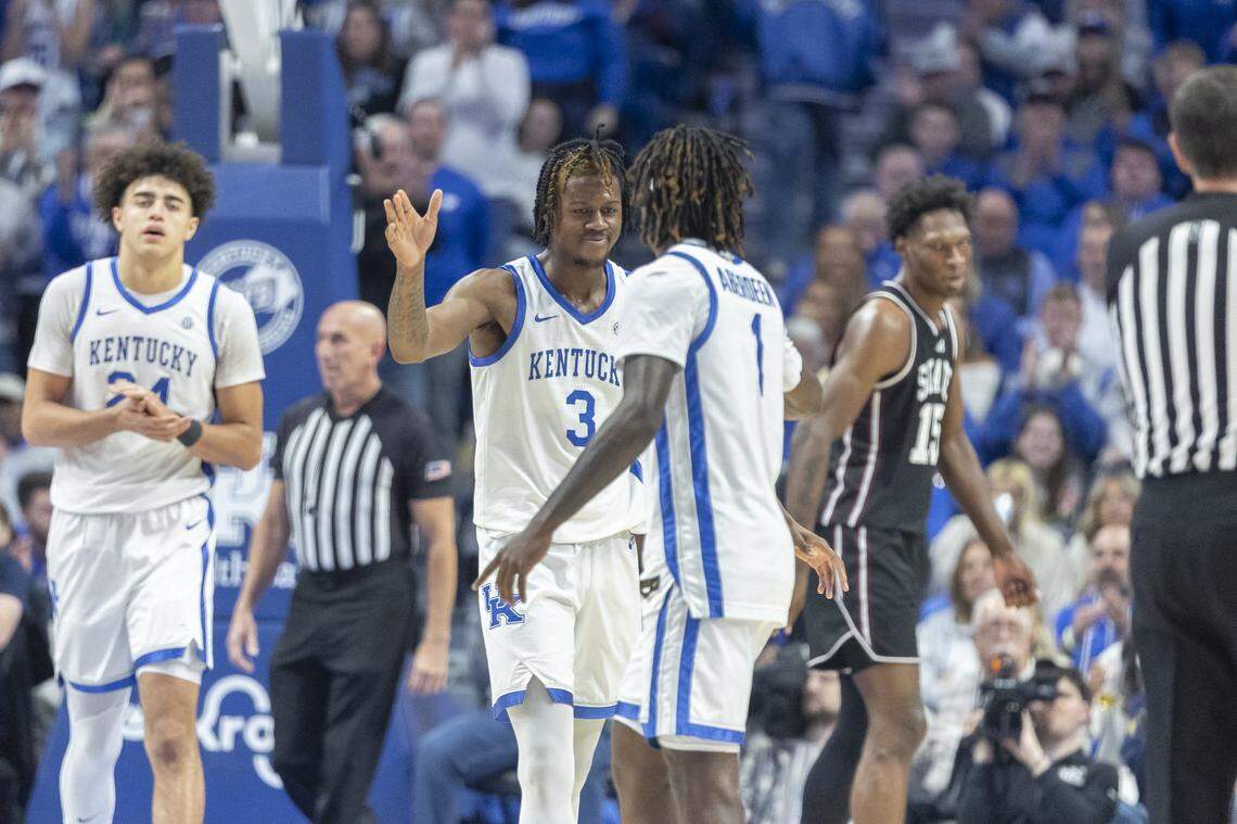 Kentucky guards Kam Williams and Denzel Aberdeen high-five during a game against the Mississippi State Bulldogs on Saturday. UK won 92-68.