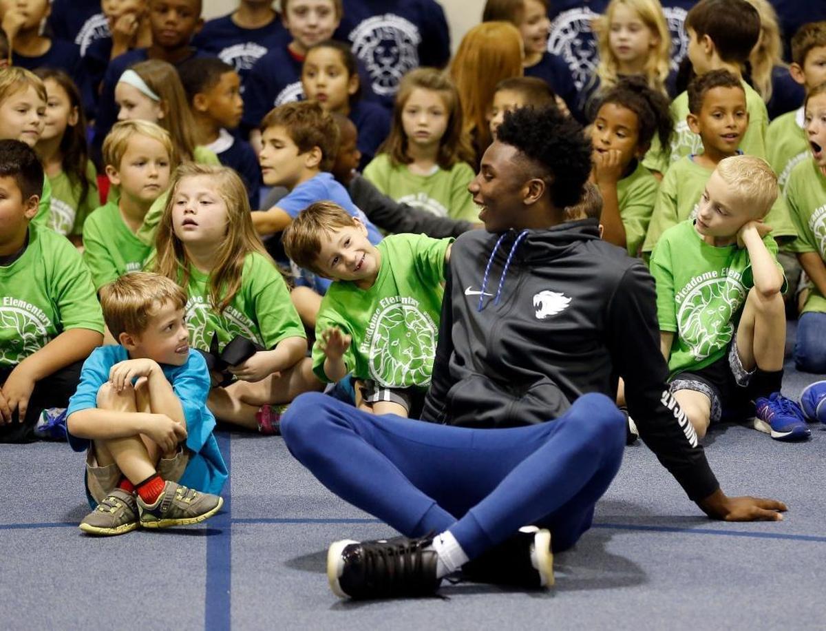 Kindergarten student Harris Barnes sat next to Hamidou Diallo as several members of the University of Kentucky men's basketball team made a visit to Picadome Elementary School, 1642 Harrodsburg Rd., in Lexington, Ky., Friday, September 15, 2017. Players delivered packed lunches to the school as part of the UK Athletics' God's Pantry program and then participated in various physical education activities and games with the students.
