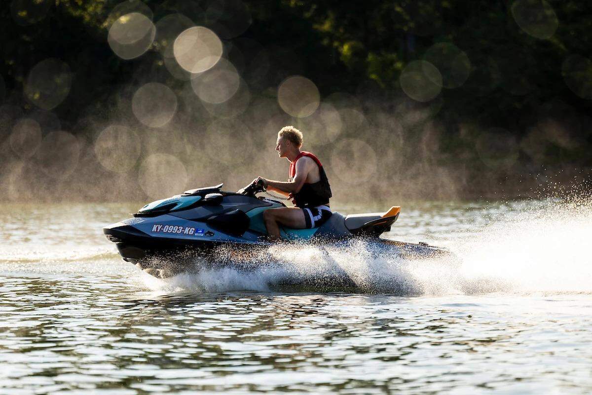 Collin Chandler rides on a jet ski during the Kentucky basketball team retreat last August at Laurel River Lake.