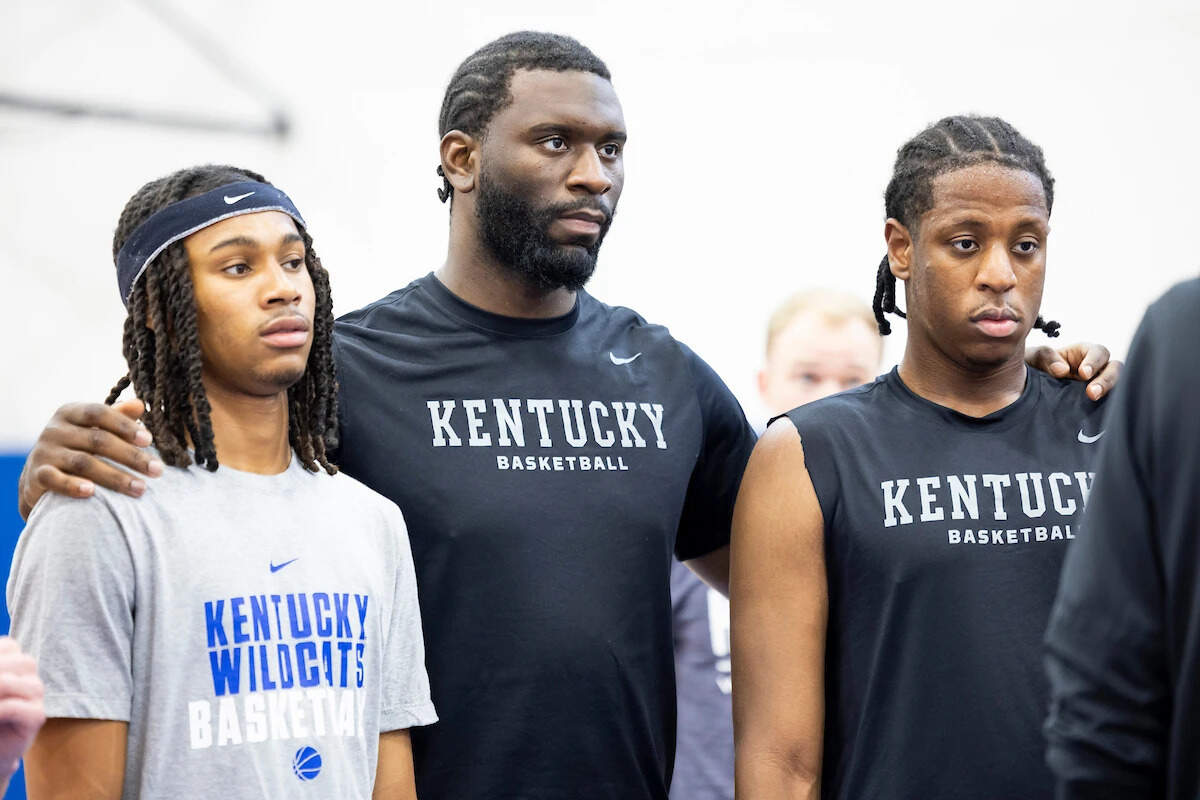 Kentucky center Franck Kepnang, center, puts his arms around new teammates Alex Wilkins, left, and Justin McBride during one of the Wildcats’ early summer practice sessions.