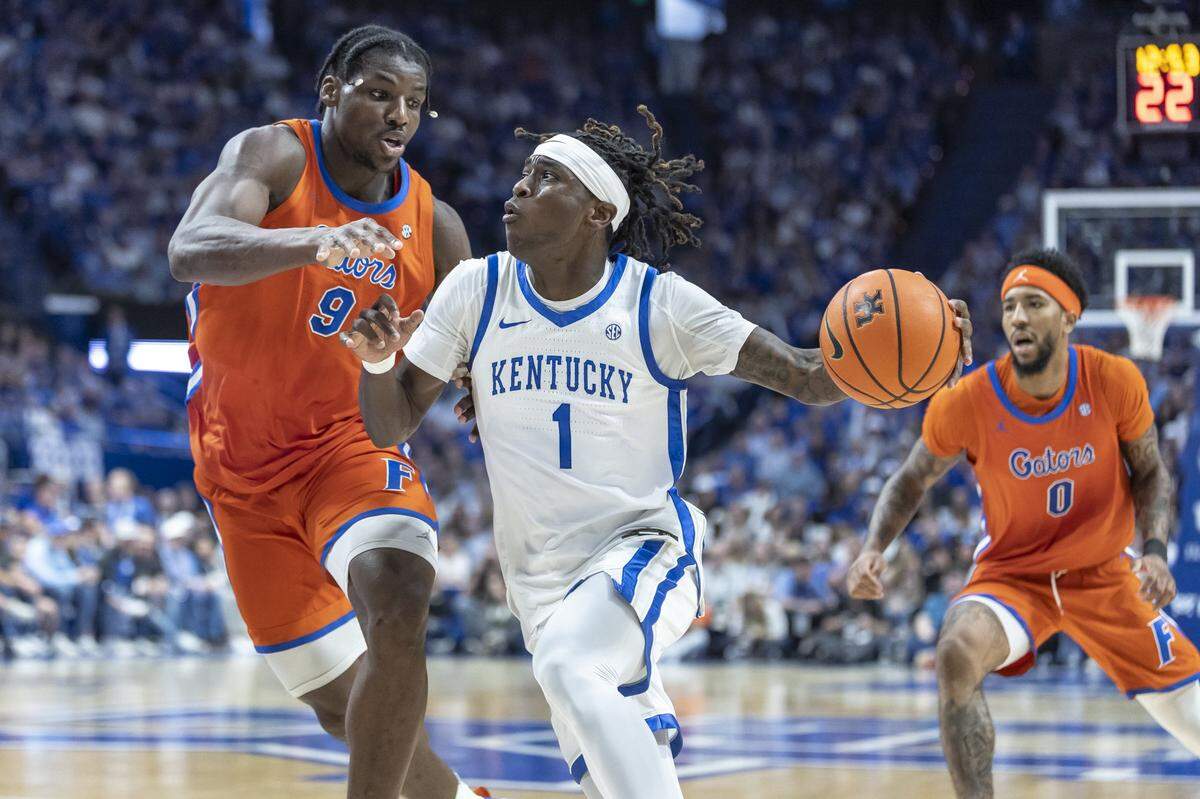 Kentucky guard Denzel Aberdeen (1) drives the ball as Florida Gators center Rueben Chinyelu (9) defends during a game at Rupp Arena in Lexington, Ky., on Saturday, March 7, 2026.