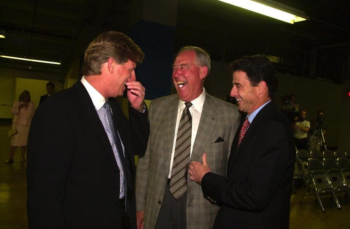 C.M. Newton, the outgoing athletics director at Kentucky, was honored at a banquet in Rupp Arena in Lexington on May 12, 2000. Newton, center, was about to loose a mint while he laughed with football coach Hal Mumme, left, and former basketball coach Rick Pitino.