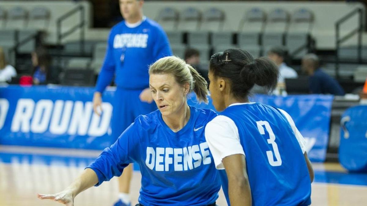 Kentucky Wildcats assistant coach Camryn Whitaker wore a defense t-shirt as she guarded Janee Thompson (3) as head coach Matthew Mitchell watched in the background at Memorial Coliseum on Friday March 18, 2016 in Lexington, Ky.