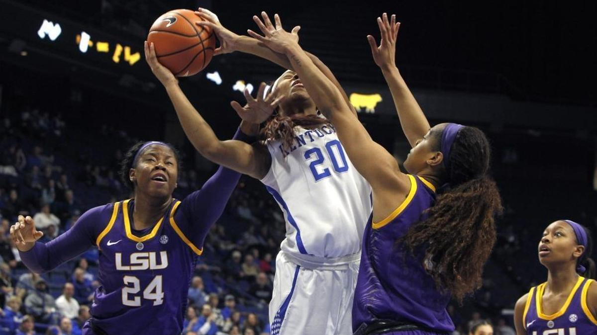Kentucky’s Dorie Harrison worked to get a shot up between two LSU defenders in Rupp Arena on Sunday.
