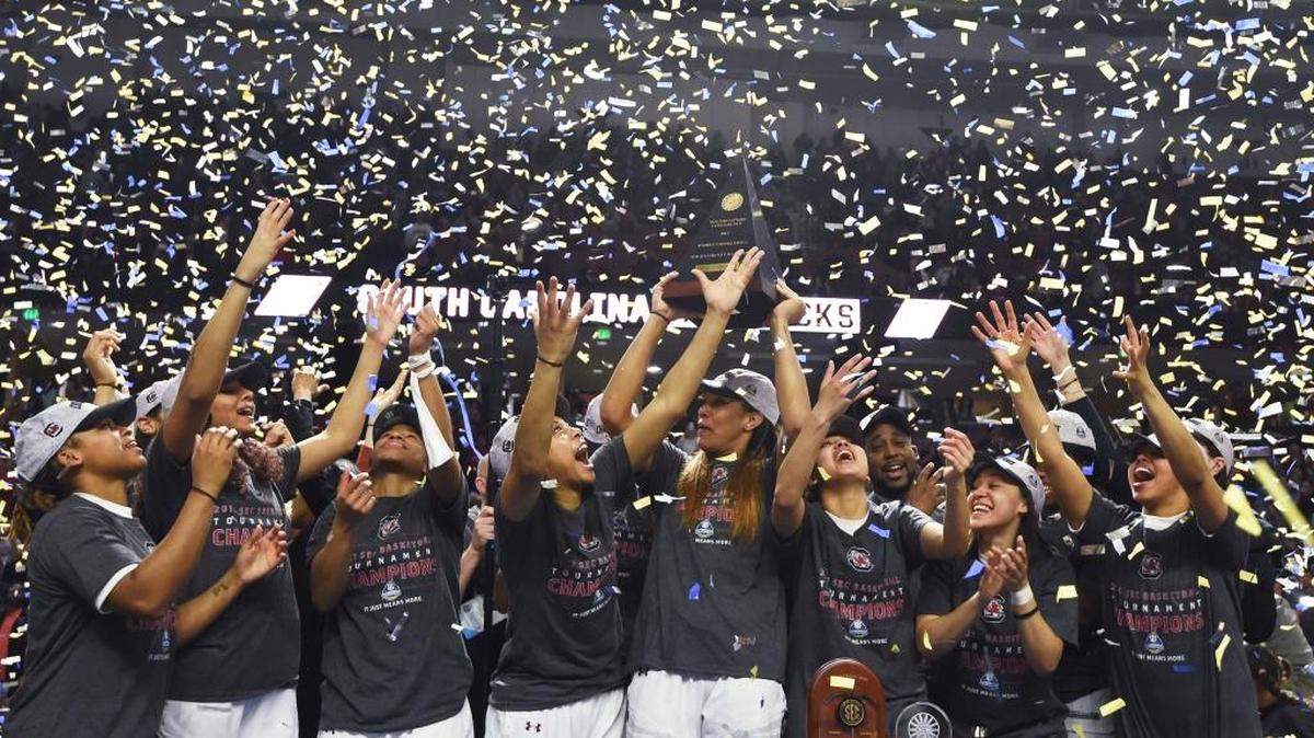 South Carolina players celebrate with the trophy after defeating Mississippi State 59-49 in an NCAA college basketball game during the Southeastern Conference tournament on Sunday, March 5, 2017, in Greenville, S.C.