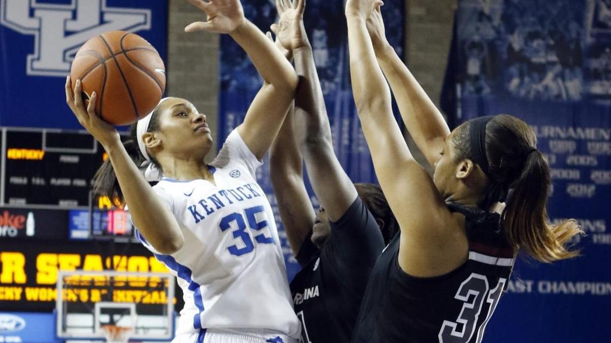 Kentucky's Alexis Jennings (35) shoots under pressure from South Carolina's Aleighsa Welch, middle, and Asia Dozier during the second half of an NCAA college basketball game, Sunday, March 1, 2015, in Lexington, Ky. Kentucky won 67-56.