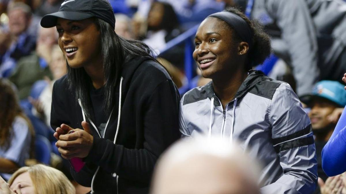 Ex-Cats Kyvin Goodin-Rogers, left, and Linnae Harper gave a standing ovation during a Kentucky run, as Kentucky defeated Louisville 72-54 on Thursday December 10, 2015 in Lexington, Ky.