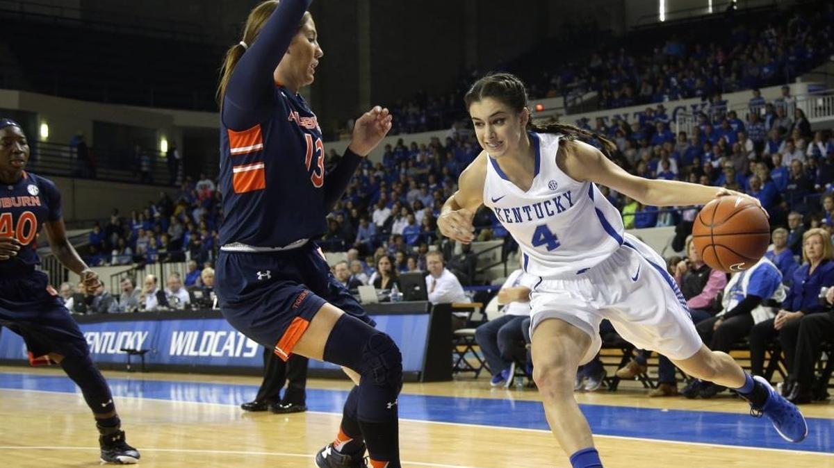 Kentucky forward Maci Morris (4) drives around Auburn guard/forward Katie Frerking (13) during the first half at Memorial Coliseum Jan. 17, 2016 in Lexington, Ky.