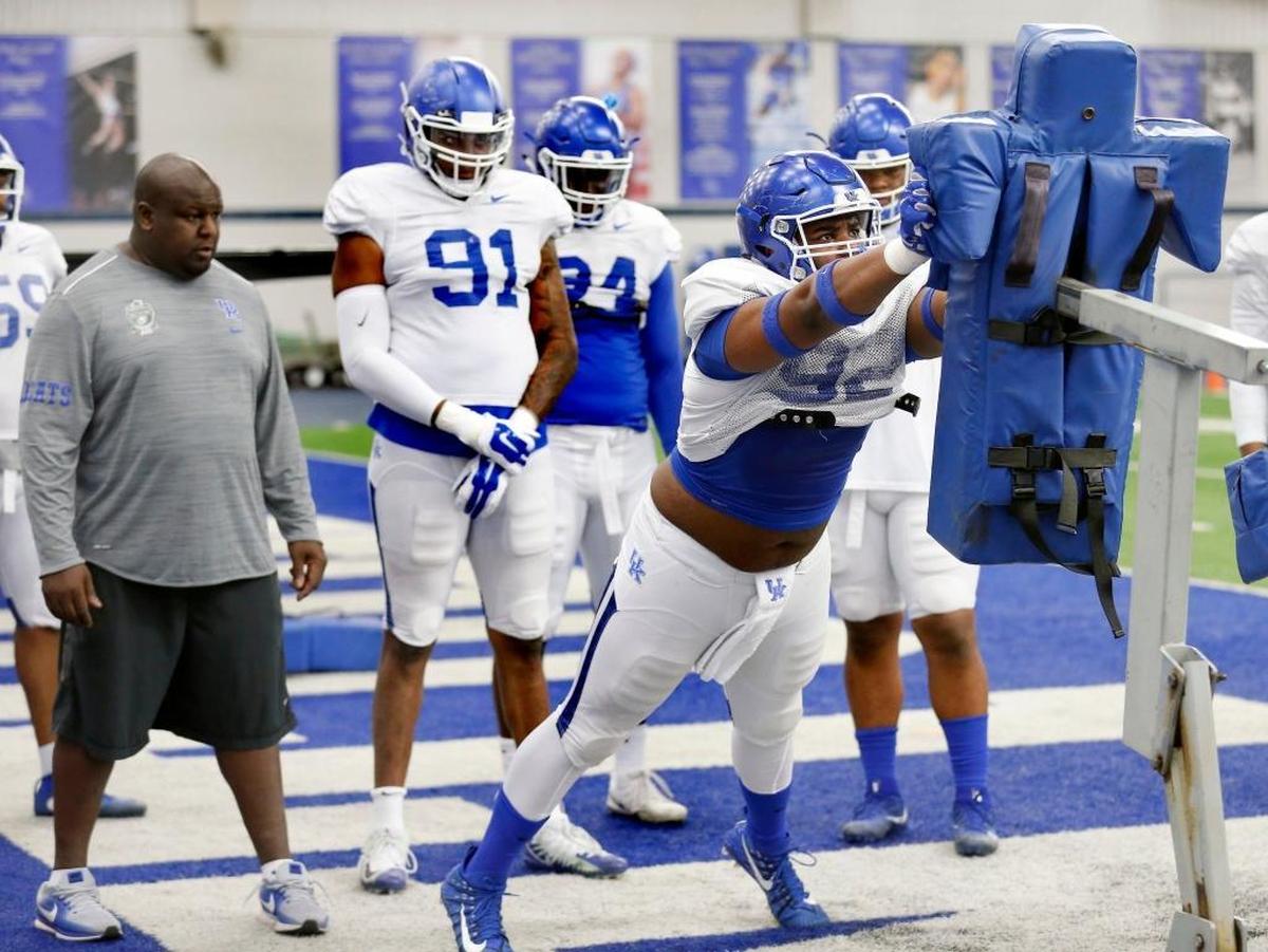 University of Kentucky football defensive line coach Derrick LeBlanc watched as defensive lineman Phil Hoskins practiced inside the Nutter Field House this spring.