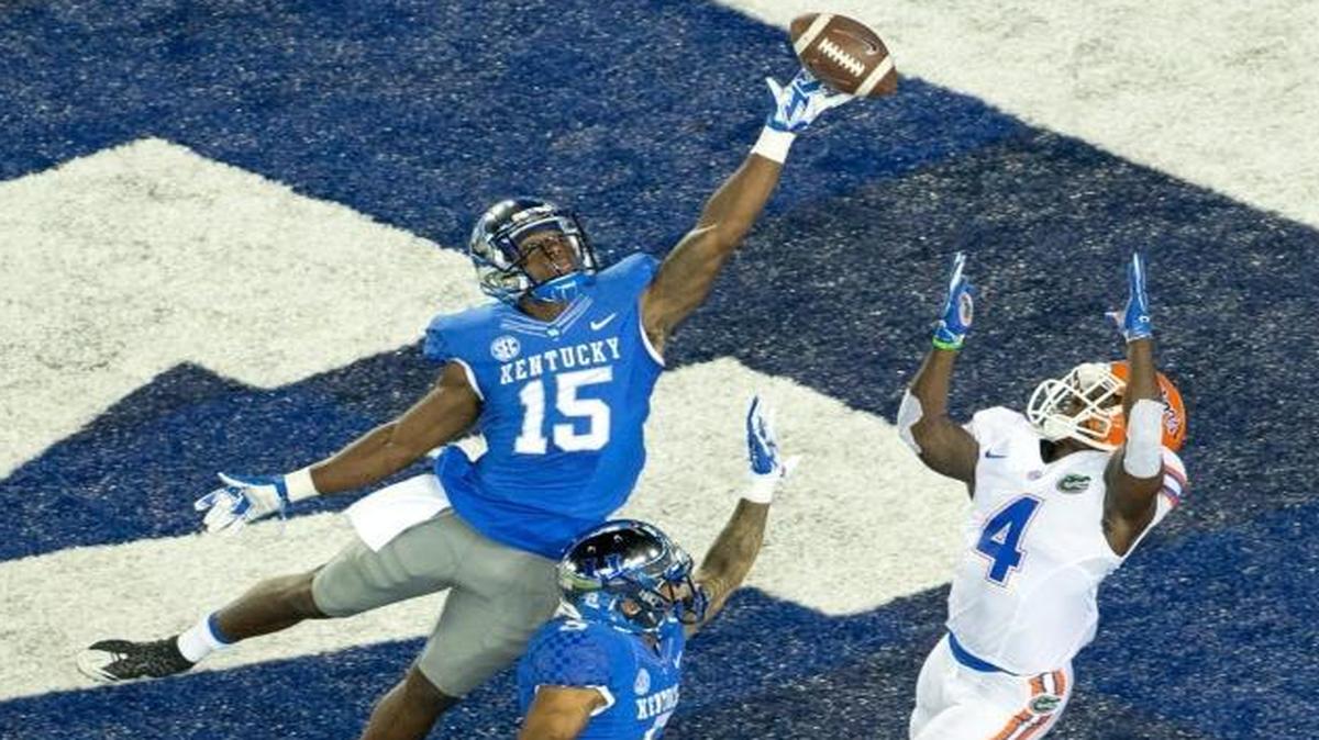 Kentucky safety Marcus McWilson (15) broke up a potential touchdown pass to Florida wide receiver Brandon Powell (4) during the first half at Commonwealth Stadium in Lexington on Sept. 19, 2015.