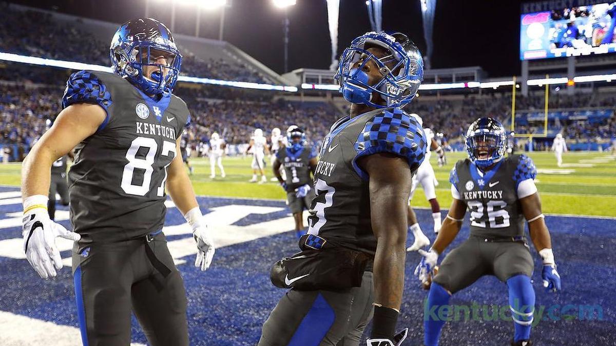 Kentucky tight end C.J. Conrad (87) celebrated with wide receiver Jeff Badet (13) after Badet made a touchdown catch in front of Mississippi State defensive back Jamal Peters (2) at Commonwealth Stadium in Lexington on Saturday, Oct. 8, 2016. UK won 40-38.