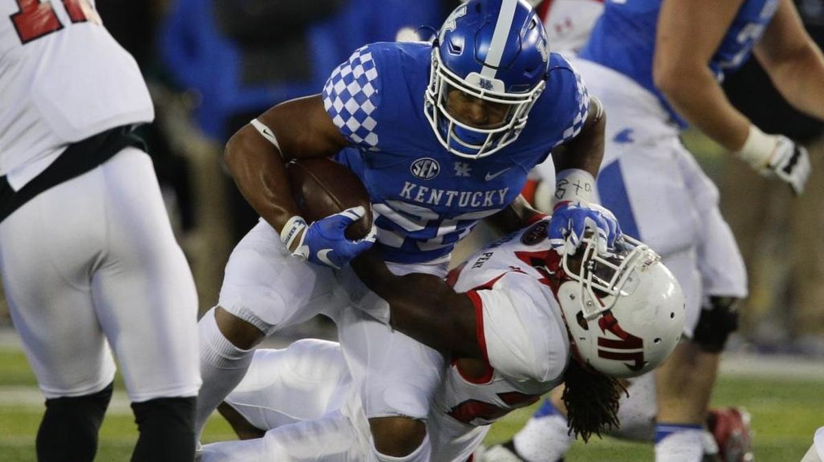 Kentucky Wildcats running back Benny Snell Jr. (26) pushed Austin Peay Governors defensive back Juantarious Bryant (26) to the ground on a first-half gain as Kentucky played Austin Peay on Saturday November 18, 2016 in Lexington, Ky.
