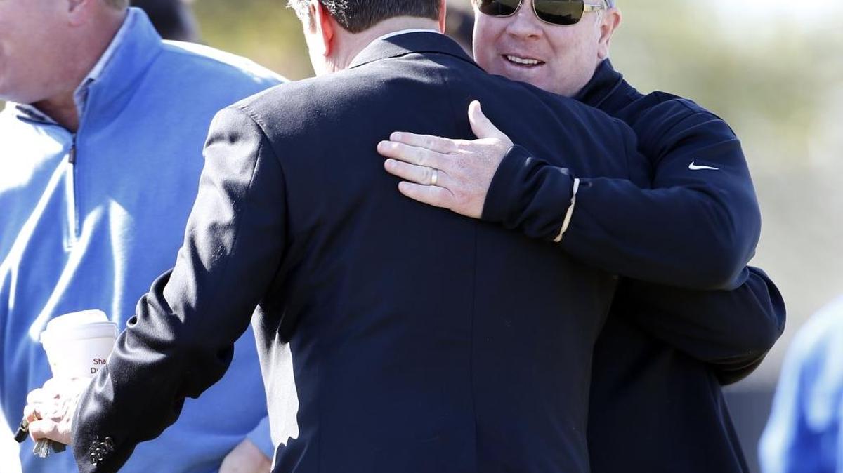 UK basketball coach John Calipari, left, hugged UK football coach Mark Stoops, in 2014 in happier times. Photo by Charles Bertram | Staff