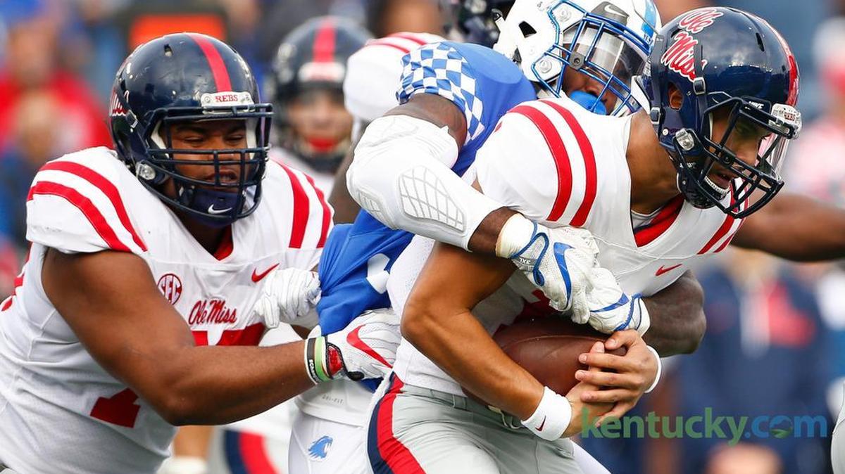 Kentucky defensive end Denzil Ware (35) sacked Mississippi quarterback Jordan Ta'amu (10) during their game at Kroger Field on Nov. 4, 2017.