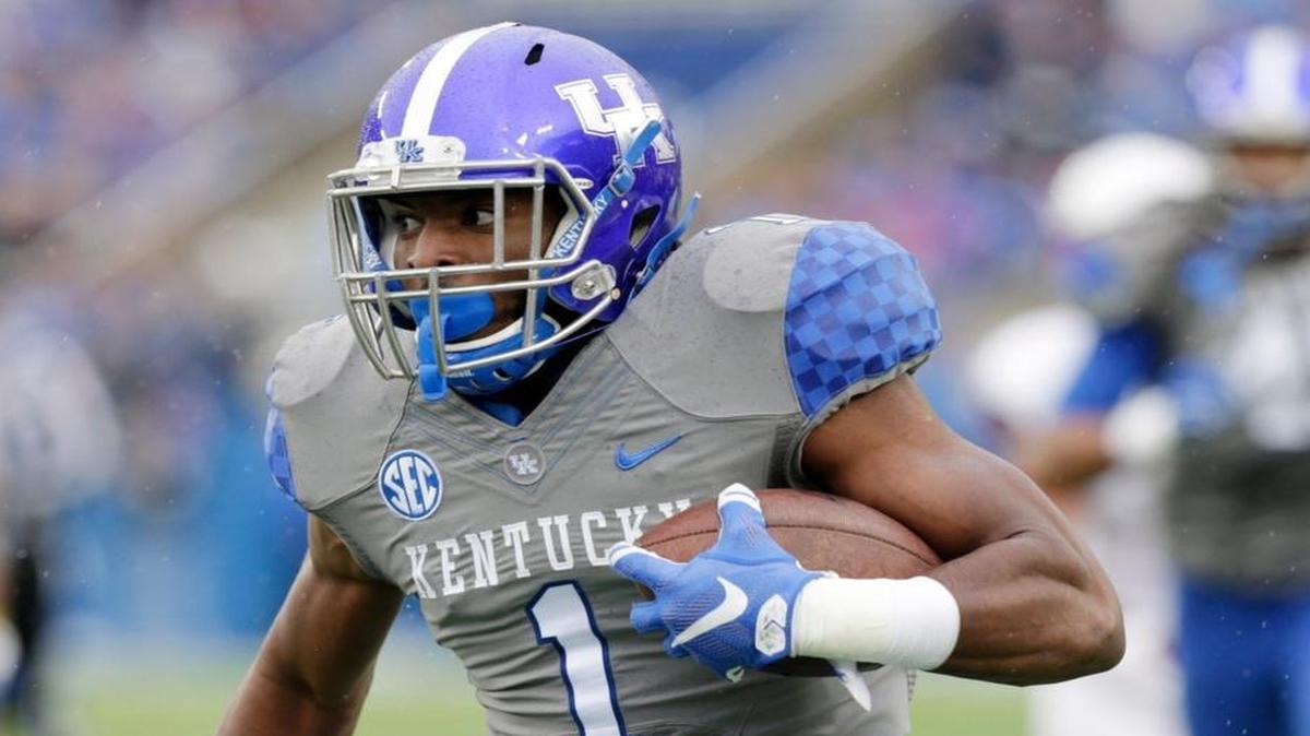 Kentucky safety A.J. Stamps (1) ran with an intercepted ball in the first quarter of the Louisville at Kentucky football game at Commonwealth Stadium in Lexington, Ky, on Nov. 28, 2015.