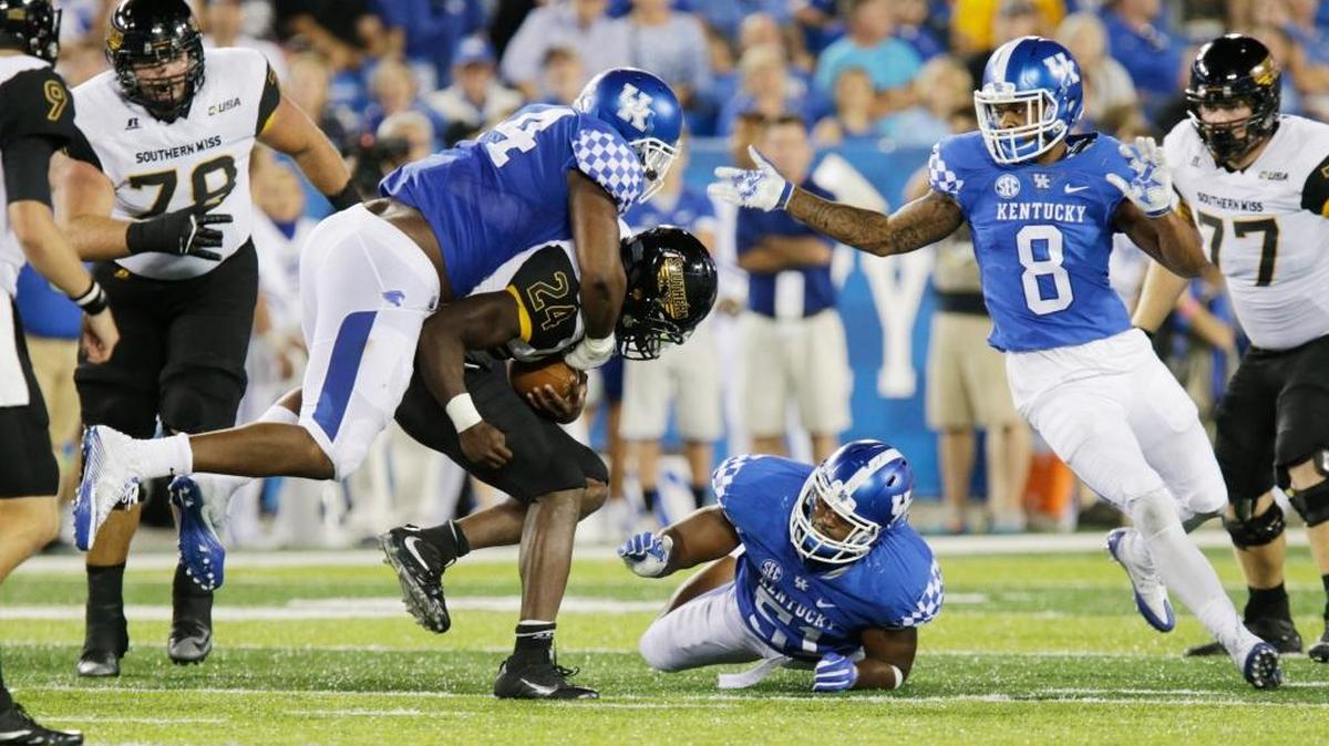 Southern Miss ‘s George Payne (24) shook off Kentucky’s Courtney Miggins (94) who had jumped on top of him and gained more yards in the fourth quarter of the Southern Mississippi at Kentucky season opening football game at Commonwealth Stadium in Lexington, Ky, on Sept. 3, 2016. Southern Miss beat Kentucky 44-35.