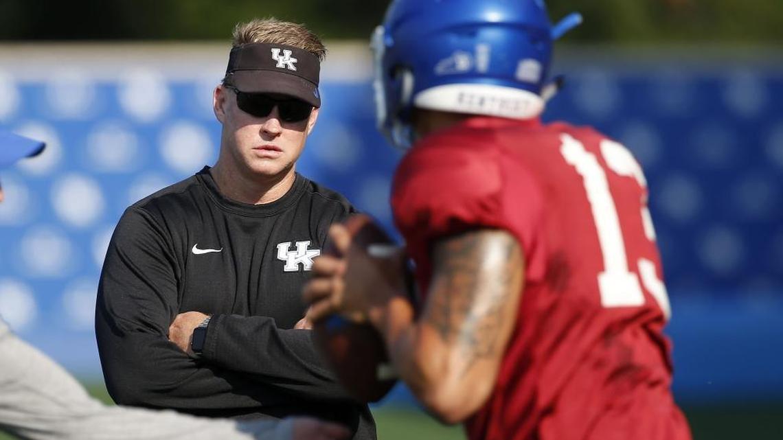 Assistant coach Darin Hinshaw watched quarterback Danny Clark throw during a UK practice. Clark is competing for the starting job this spring with Gunnar Hoak and Terry Wilson.