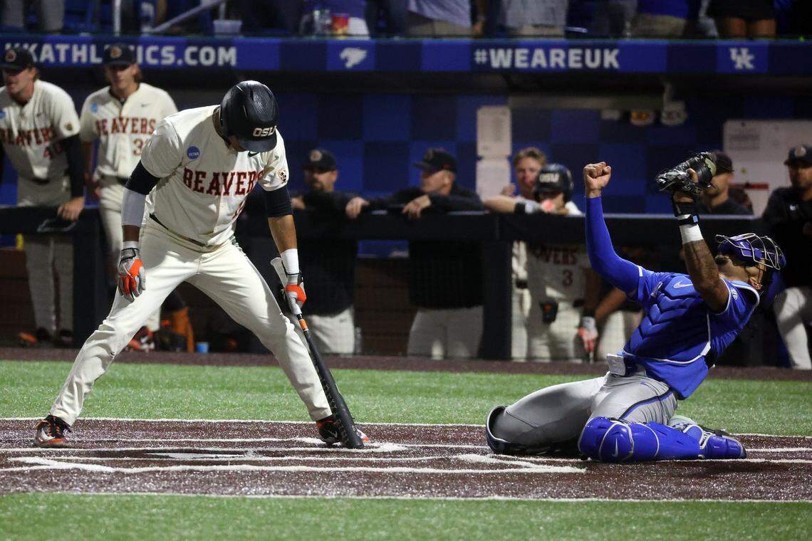 Oregon State’s Micah McDowell, left, reacts after striking out at the end of the game as Kentucky catcher Devin Burkes celebrates in game two of the super regional in Lexington, Ky, Sunday, June 9, 2024.