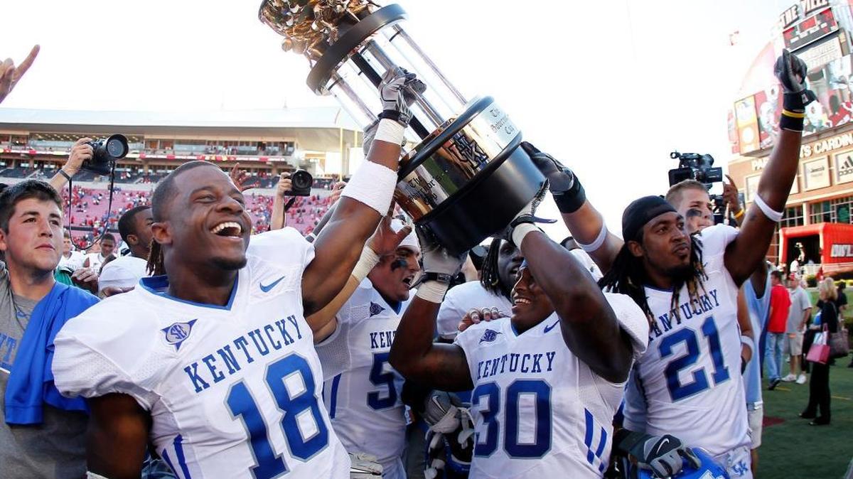 Kentucky's Randall Cobb, 18, and Moncell Allen, raised the Governor's Cup trophy as Kentucky defeated Louisville 23-16 in Papa Johns Stadium on Saturday September 4, 2010 in Louisville, Ky. Photo by Mark Cornelison | Staff