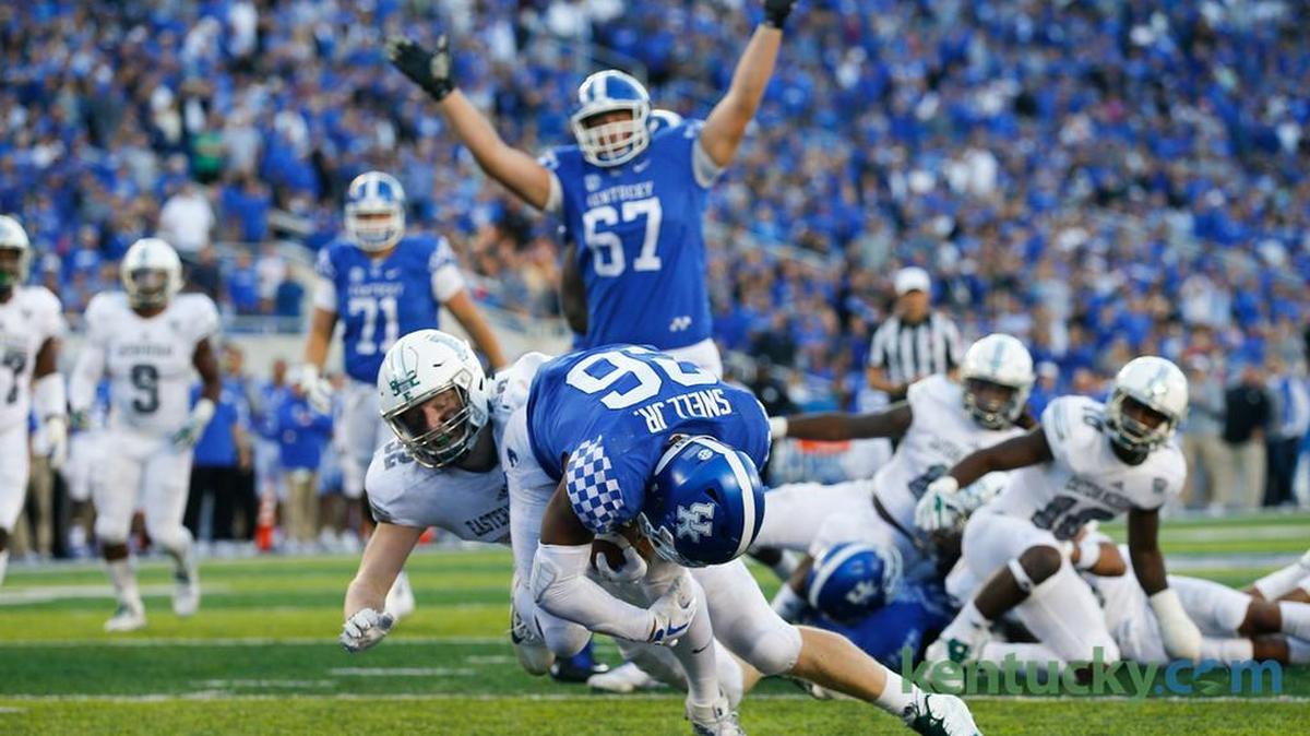 Kentucky offensive tackle Landon Young (67) celebrated as running back Benny Snell (26) scored a touchdown in UK’s 24-20 victory over Eastern Michigan at Kroger Field last season.